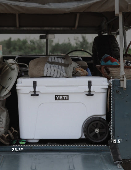 White YETI cooler in a vehicle with various items around