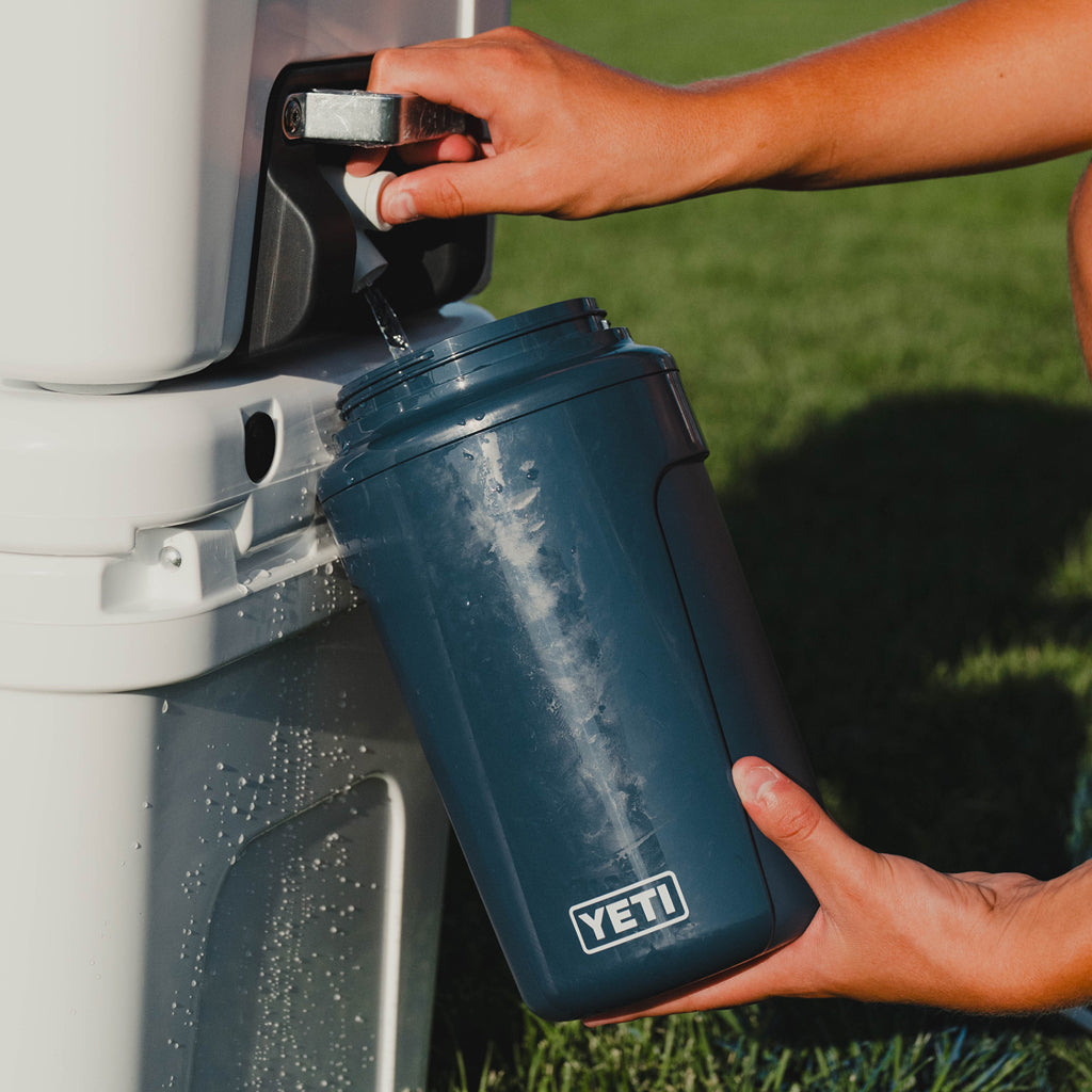 A person filling up a Yeti Silo Jug.