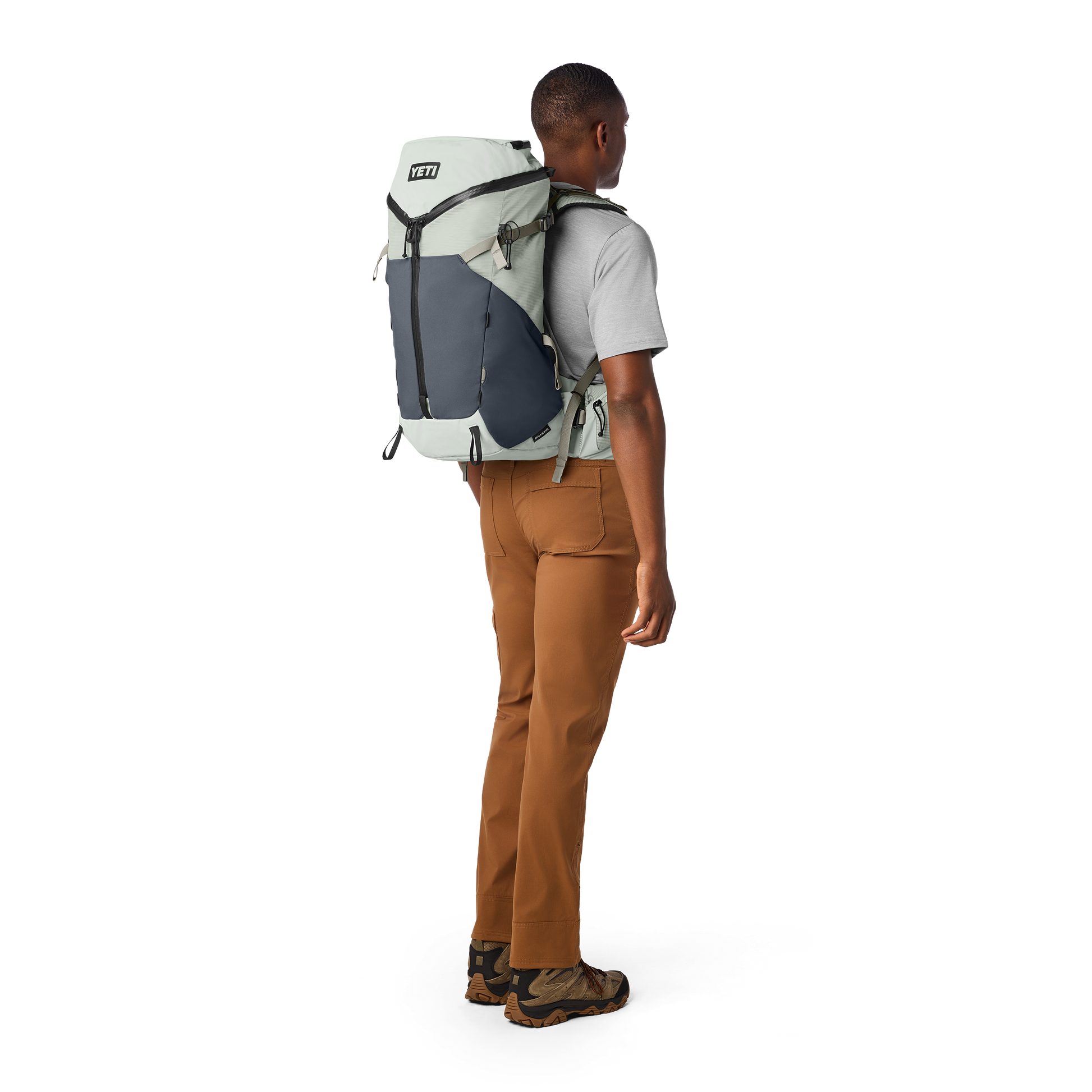 Person wearing a large backpack on a white background